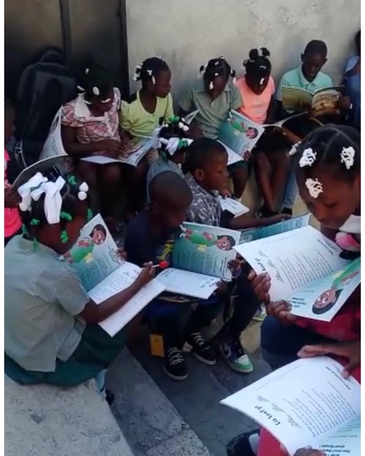 Two girls in school uniforms reading Nan Jaden Amoni